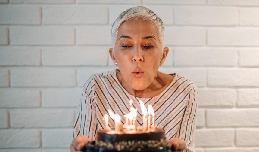 Woman blowing out birthday candles
